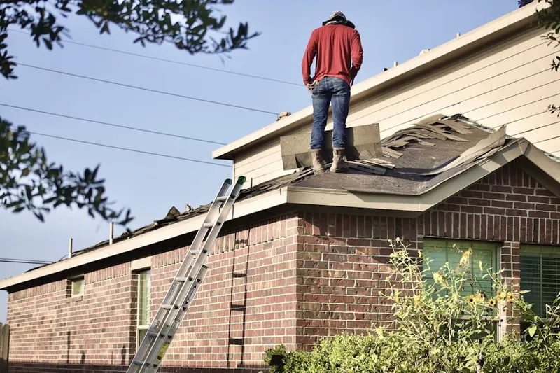 Professional roofer working on a residential roof in Meridian